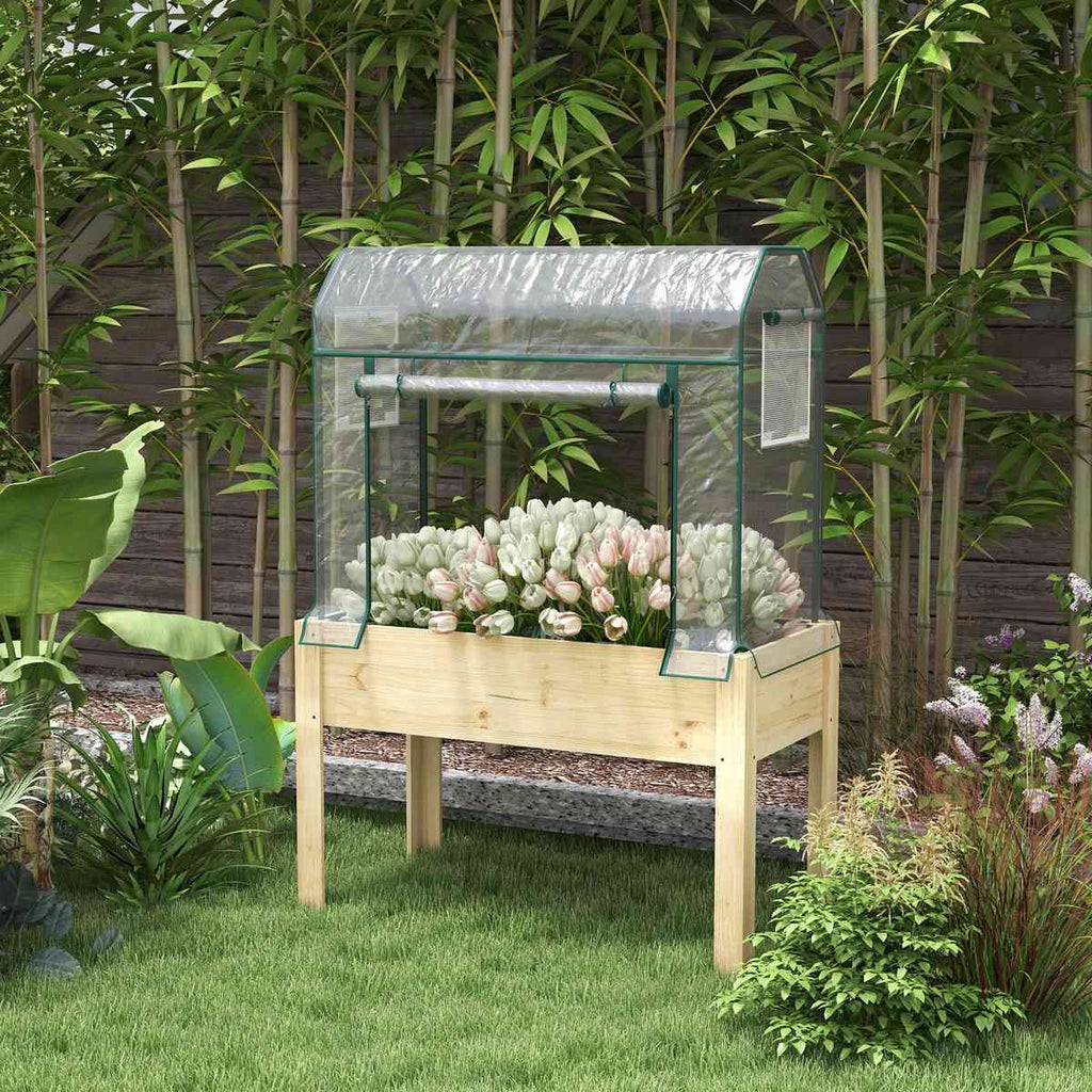 Bac potager sur pieds avec serre et fleurs au jardin