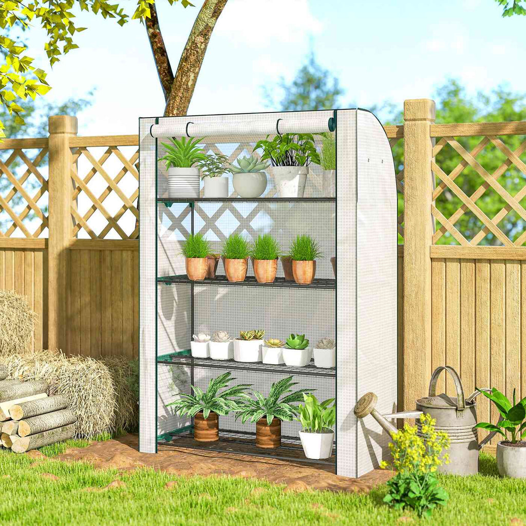 Serre de balcon blanche contenant des plantes près d’une clôture en bois