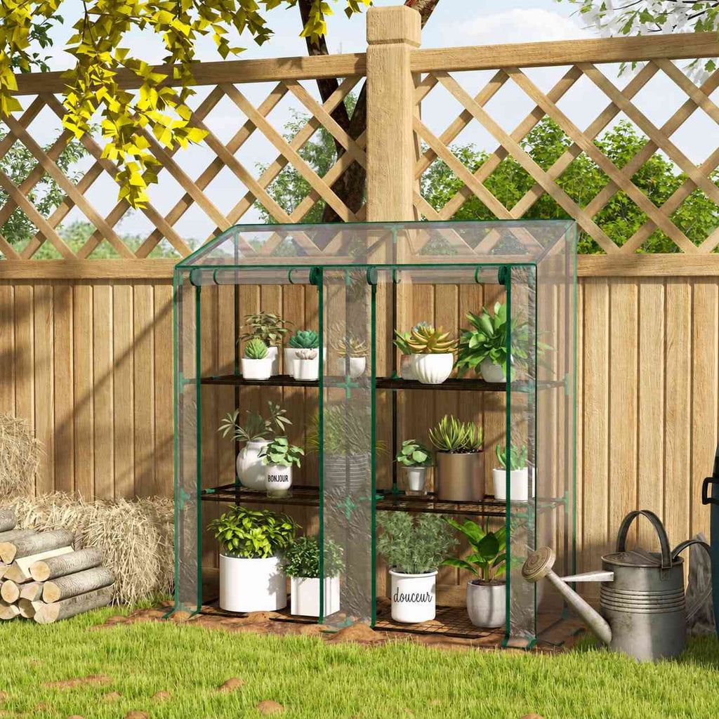 Serre transparente avec plantes devant un treillage