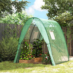 Serre verte ogivale avec bac potager et plantes dans le jardin