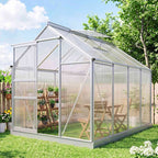 Serre argentée au jardin avec porte ouverte et lucarne relevée