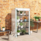 Serre de balcon blanche avec plantes en pots contre un mur en briques