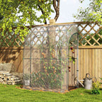 Serre adossée transparente abritant des tomates près d’une clôture en bois