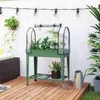Bac potager vert avec serre, plantes et roulettes sur une terrasse en bois