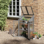 Armoire serre grise ouverte avec plantes contre un mur