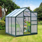 Serre verte au jardin avec table de culture et plantes fleuries