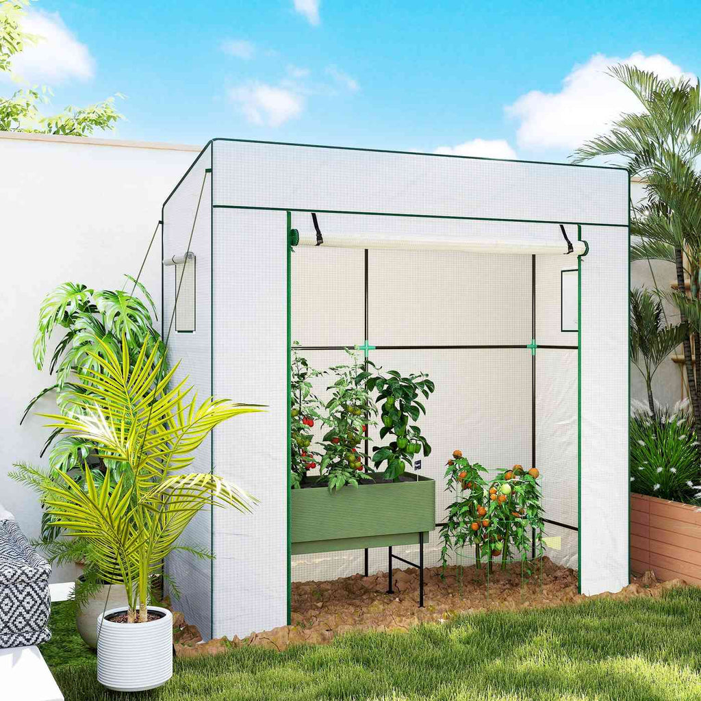 Serre blanche avec bac potager et plantes sur une terrasse