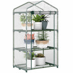 Mini serre transparente avec plantes sur trois étagères