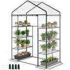 Serre transparente avec plantes en pots et piquets d’ancrage fournis