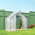 Serre transparente avec plantes sur une pelouse
