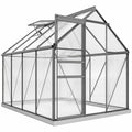 Serre grise en polycarbonate avec porte coulissante et lucarne ouverte