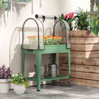 Bac potager vert avec serre et fleurs sur une terrasse
