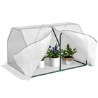 Mini-serre blanche à grande ouverture avec plantes fleuries en pots
