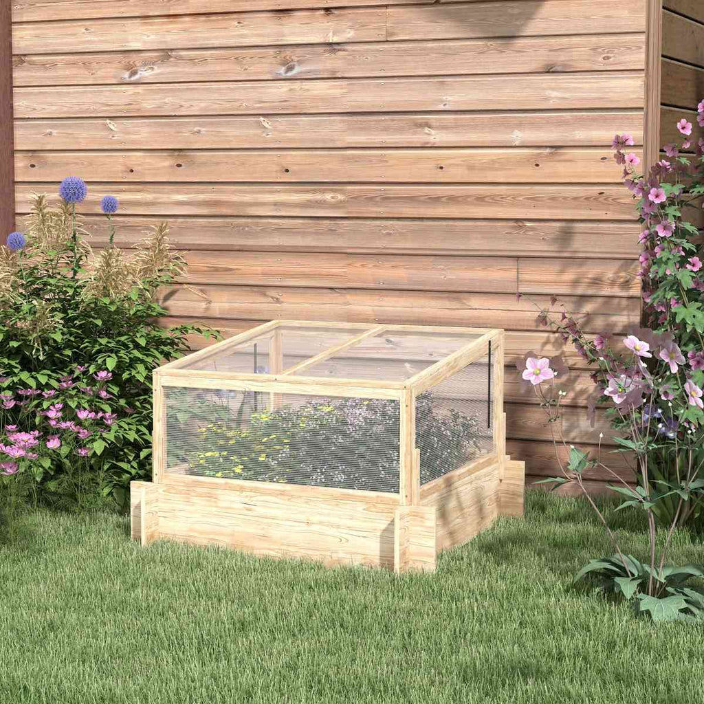 Carré potager en bois avec serre installé près d’un mur
