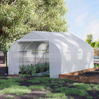 Serre tunnel blanche au jardin avec plantes devant l’entrée