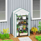 Mini serre blanche avec plantes près d’un bâtiment