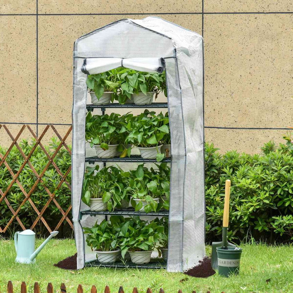 Serre blanche à quatre étagères garnies de plantes au jardin